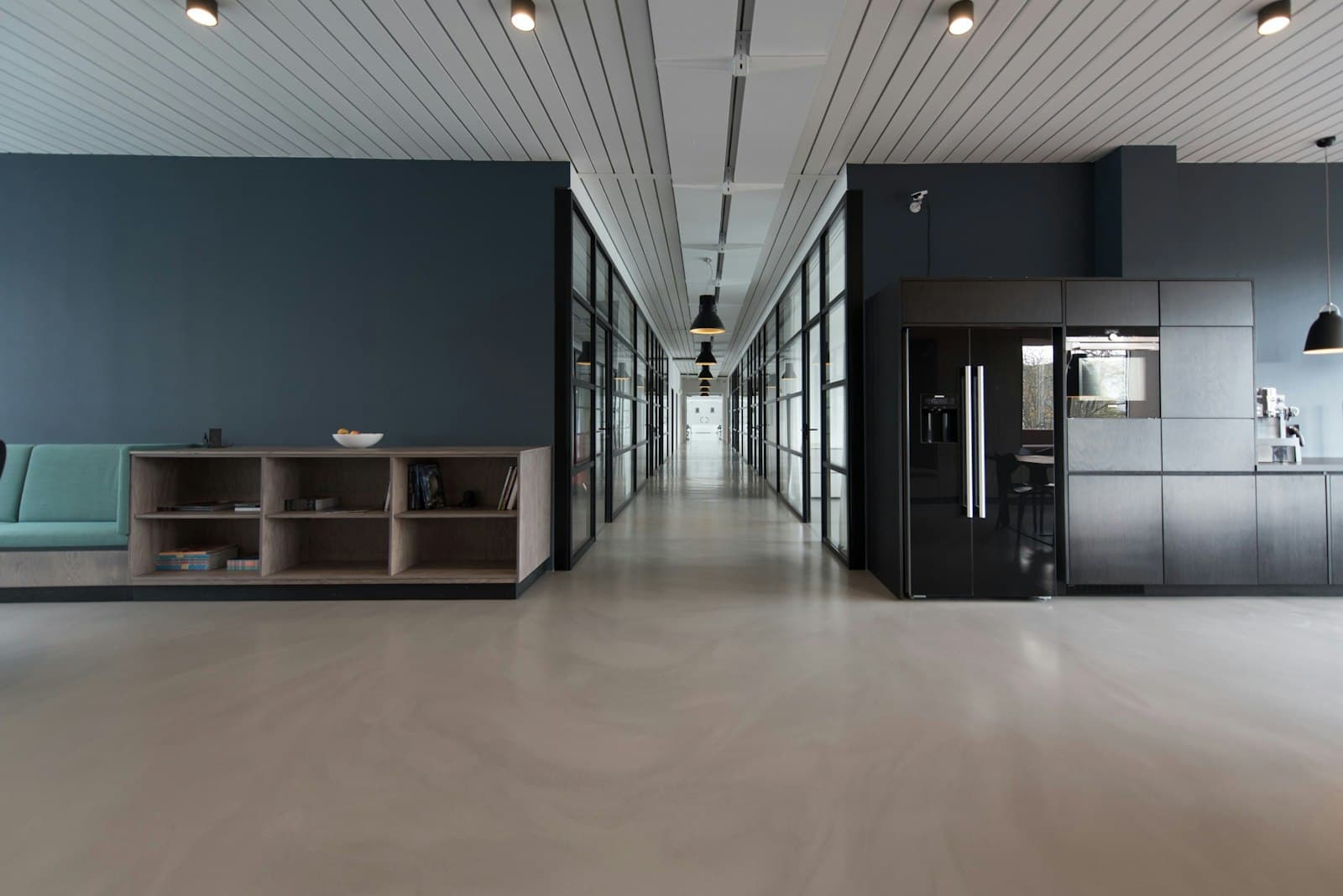 Office interior with a long work table and quiet materials